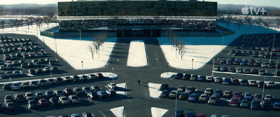 a parking lot filled with lots of parked cars