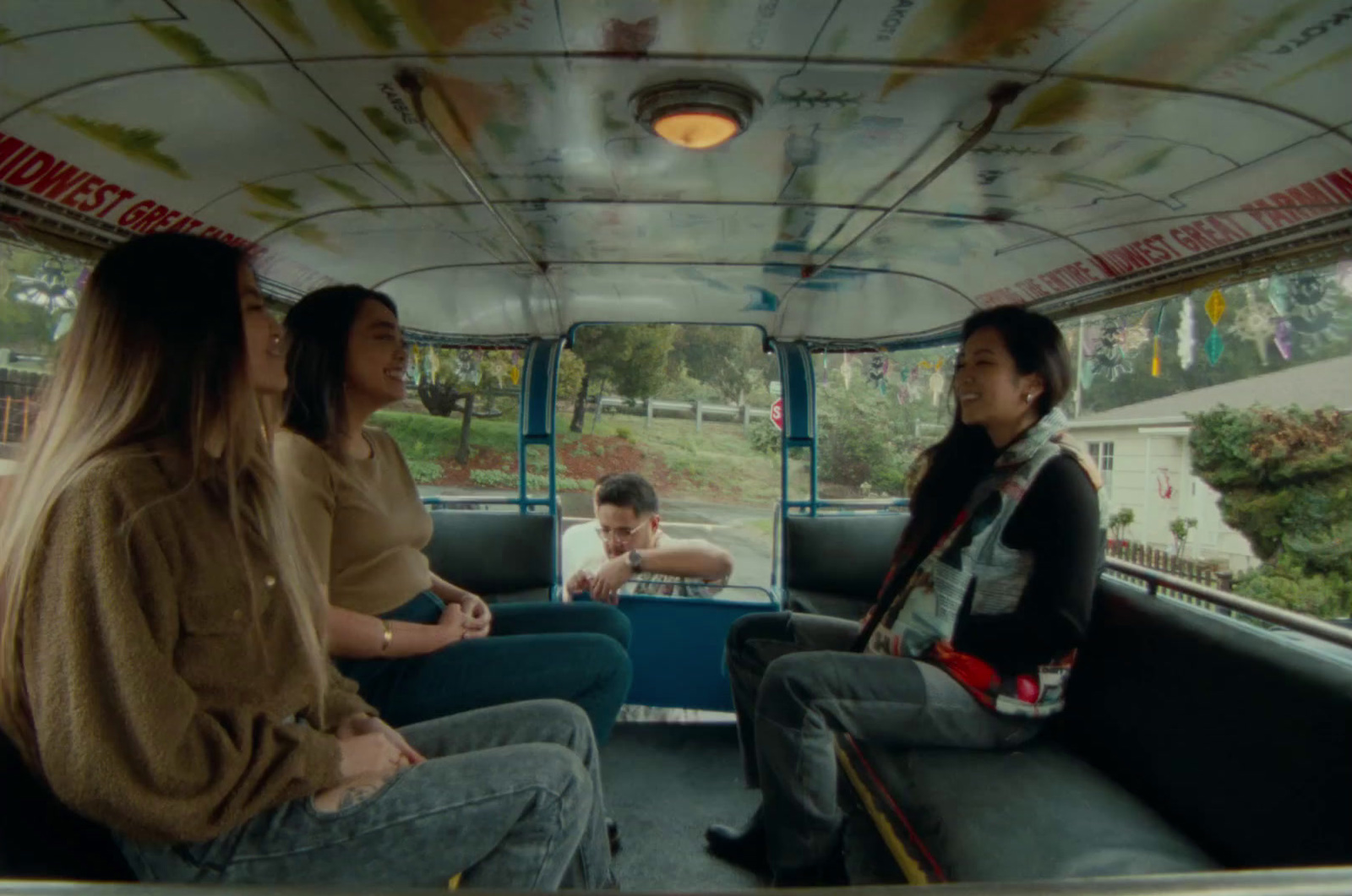 a group of people sitting on top of a bus