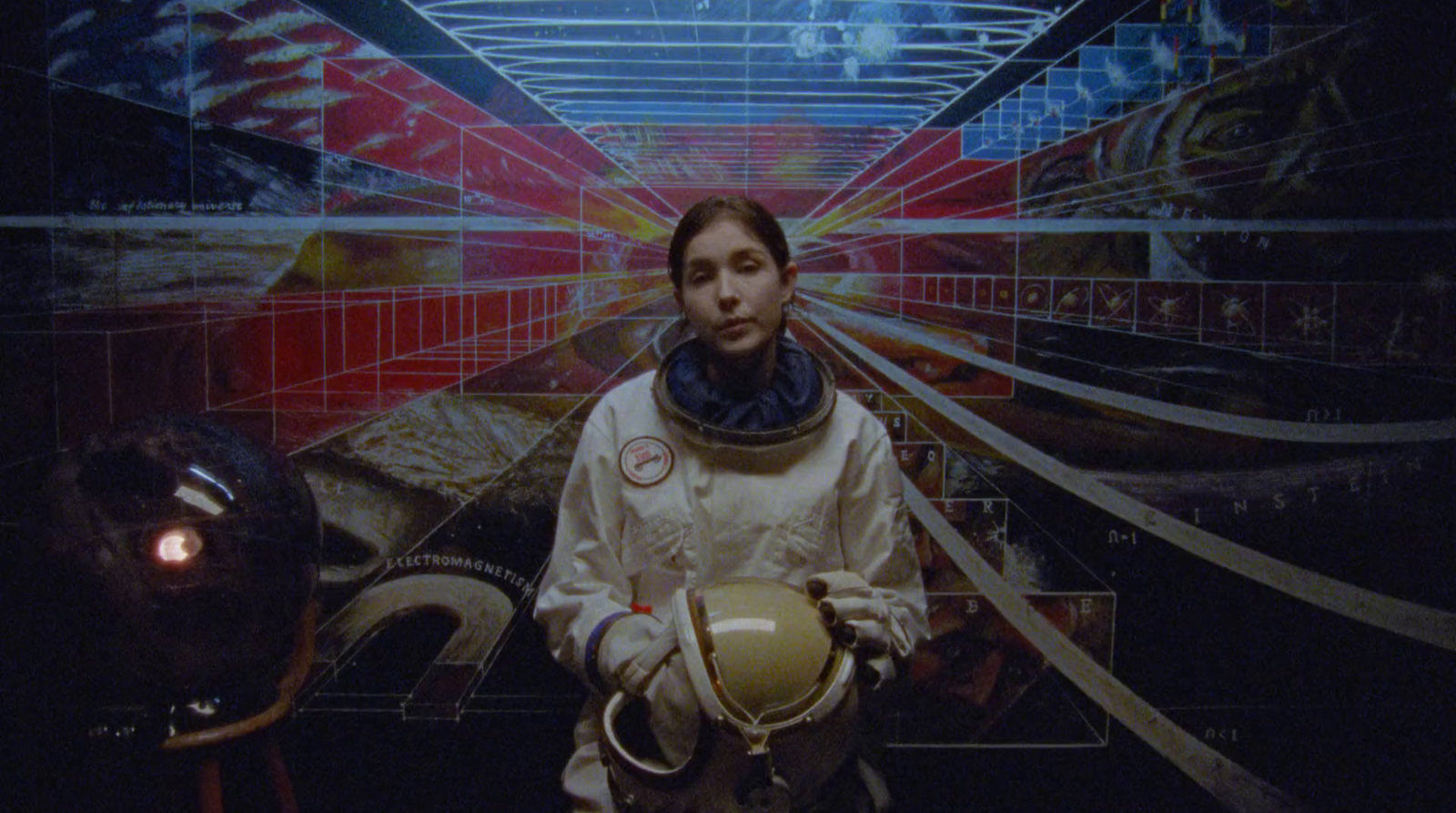 a woman in a space suit standing in front of a painting