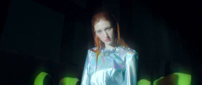 a woman with red hair in a shiny outfit