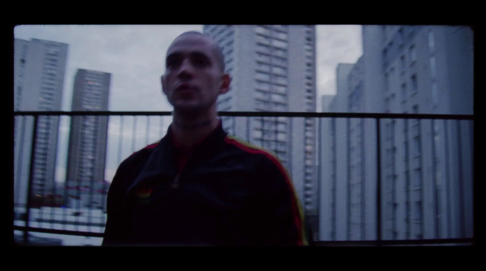 a man standing in front of tall buildings