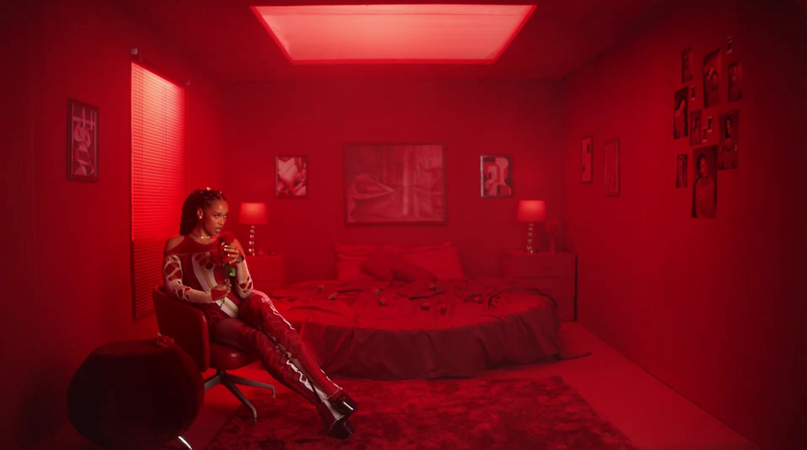 a woman sitting on a chair in a red room