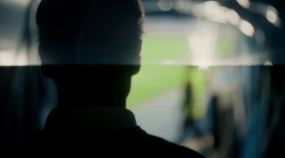 a man standing in front of a window with a blurry background