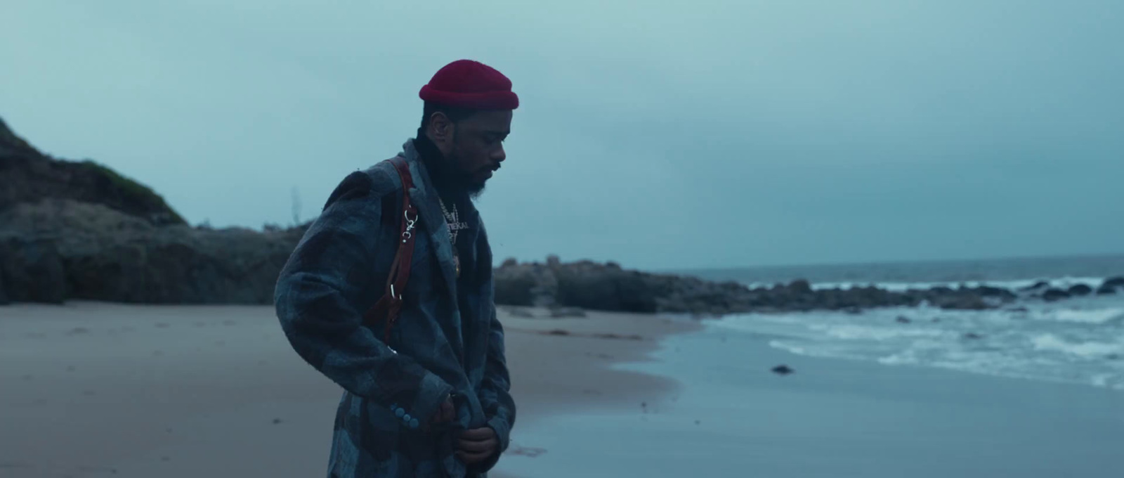 a man standing on a beach next to the ocean