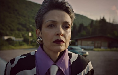 a woman in a black and white shirt and purple tie