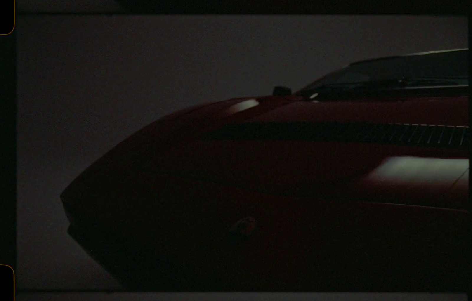 a picture of a red sports car in the dark