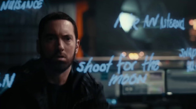 a man standing in front of a wall with writing on it