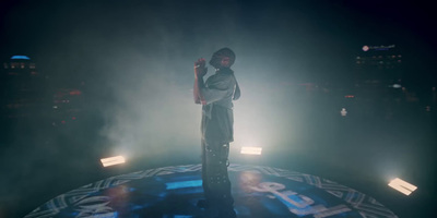 a man standing on top of a stage holding a microphone