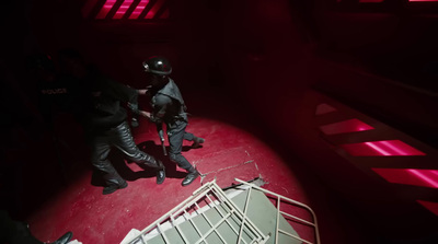 a couple of people standing on top of a red object