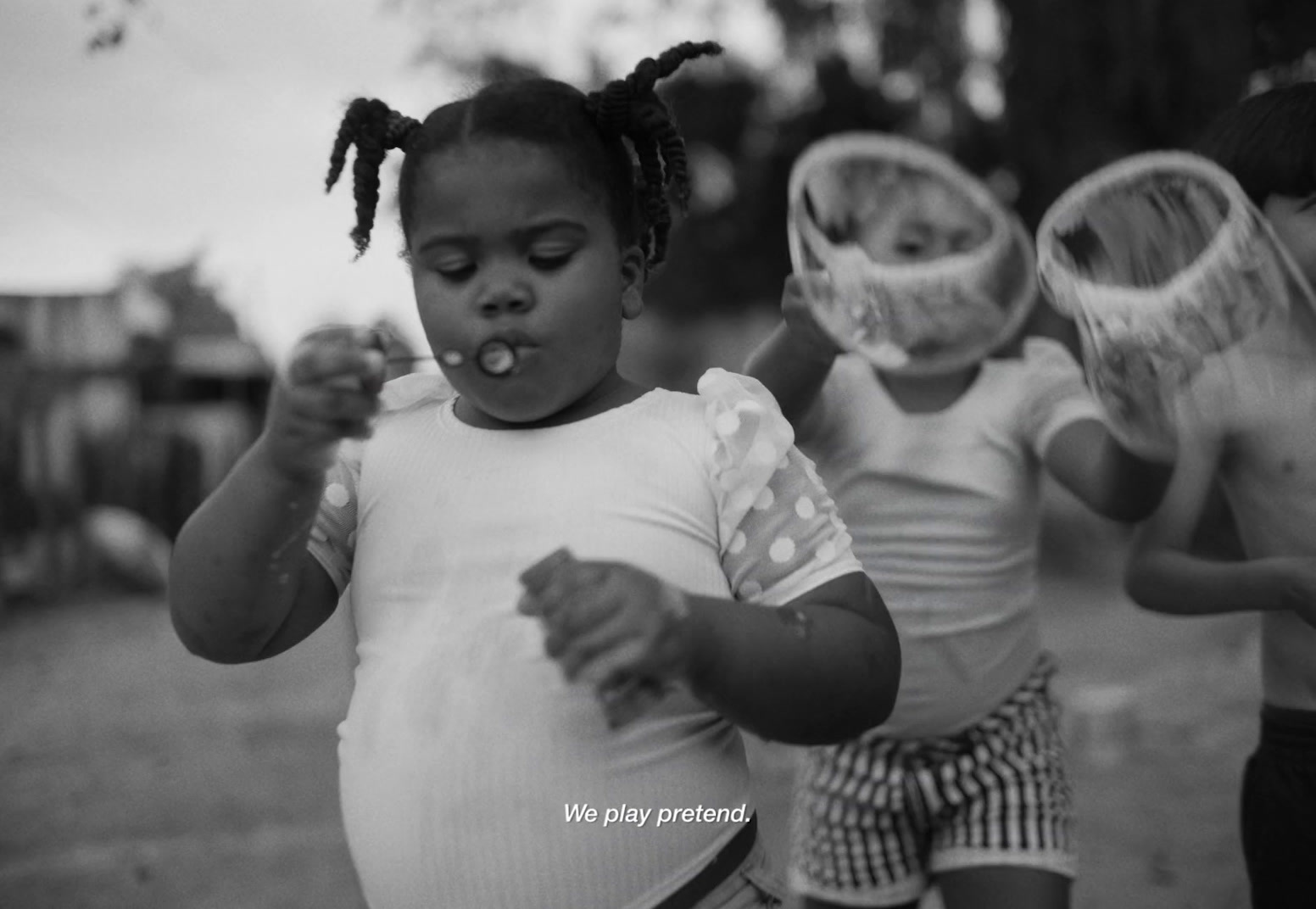 a black and white photo of three little girls