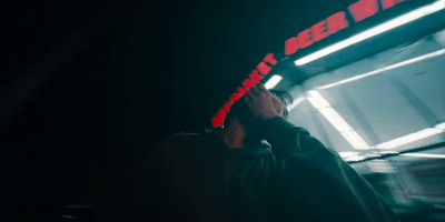 a man standing in front of a building at night