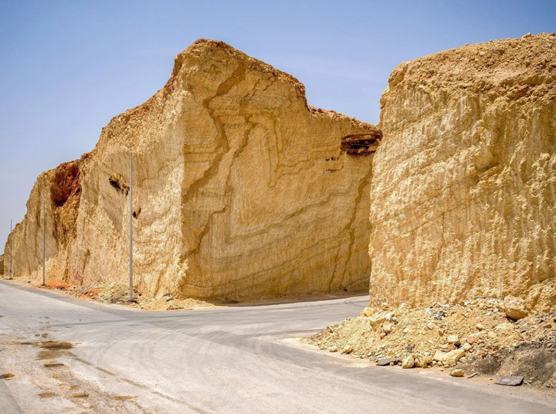 a road that has some very big rocks on it