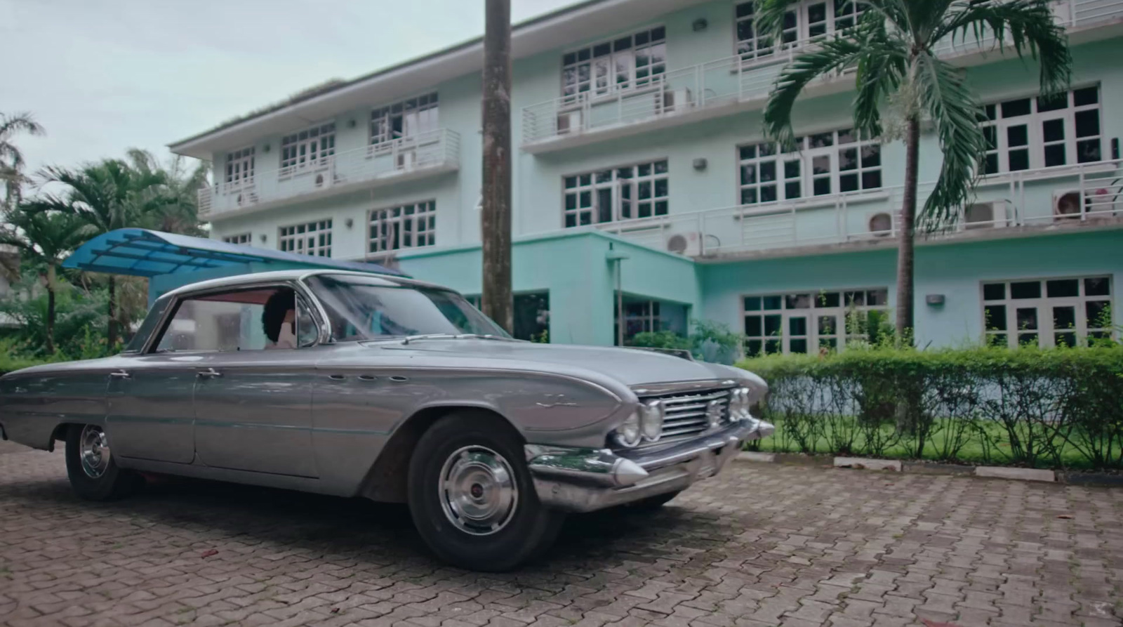 an old car with a surfboard on top of it