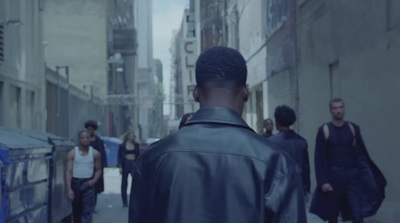 a group of people walking down a city street