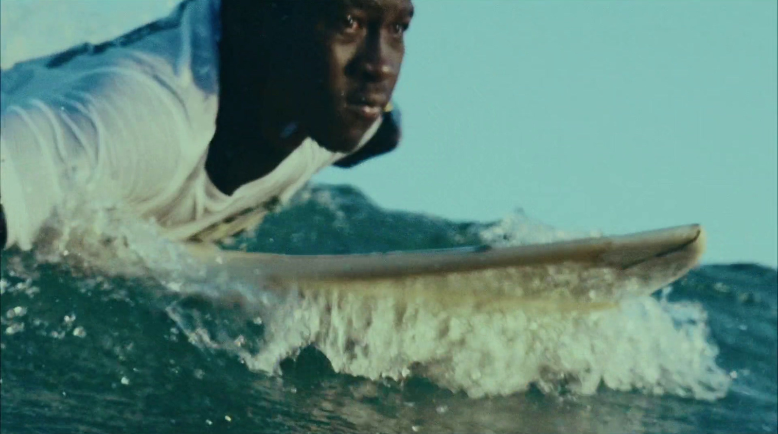 a man riding a wave on top of a surfboard