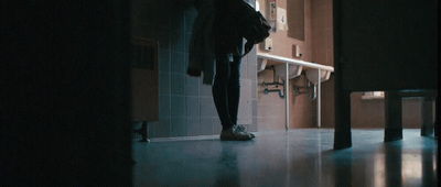 a person standing in a bathroom next to a sink