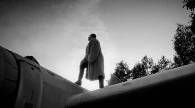 a man standing on top of a roof next to trees