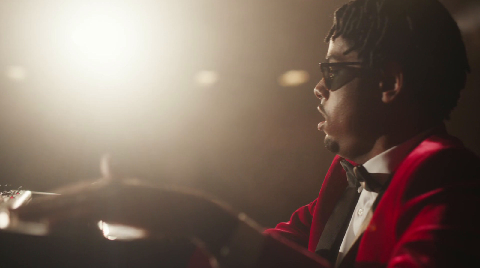 a man in a red jacket and bow tie