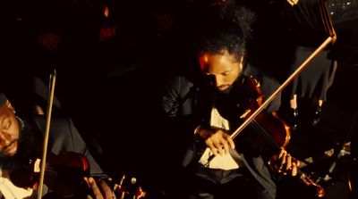 a group of men playing instruments in a dark room