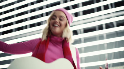 a woman in a pink sweater holding a white heart