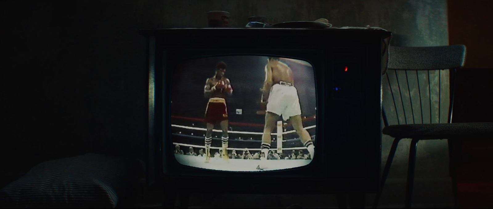 an old television with a female boxer on it