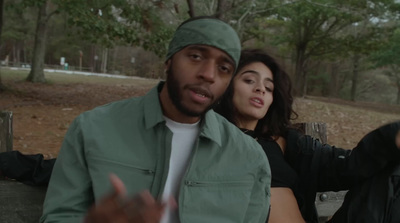 a man and a woman sitting on a park bench