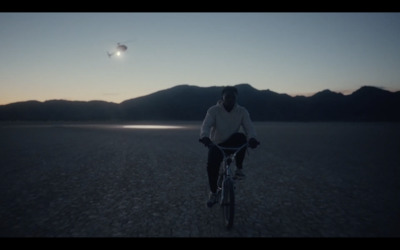 a man riding a bike in the middle of a desert