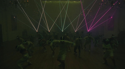 a group of people dancing in a dark room