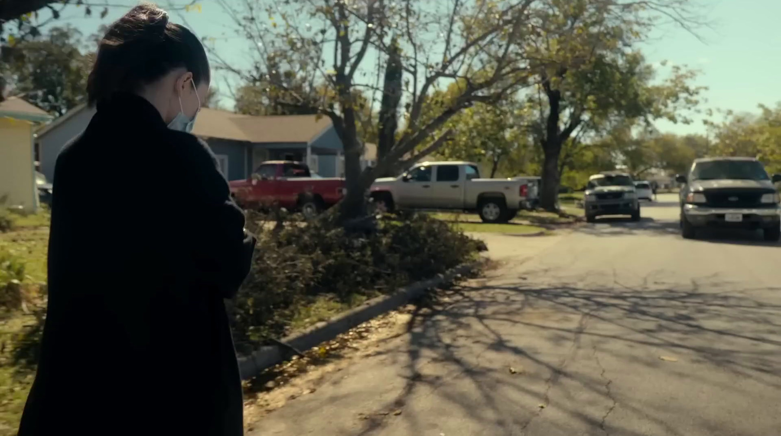 a woman standing on the side of a road