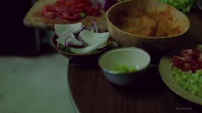 a wooden table topped with bowls of food