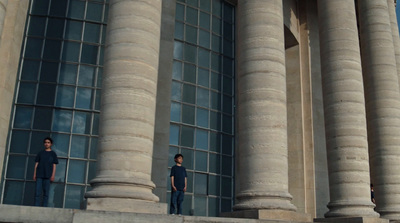 a couple of people standing in front of a building