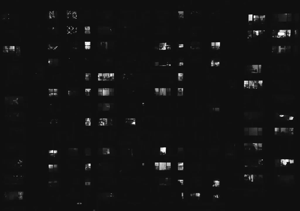 a black and white photo of a building at night