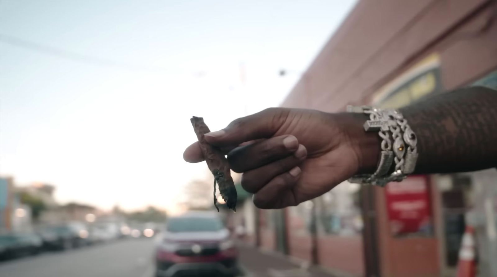 a person holding a cell phone on a city street