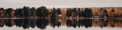 a body of water surrounded by trees and houses