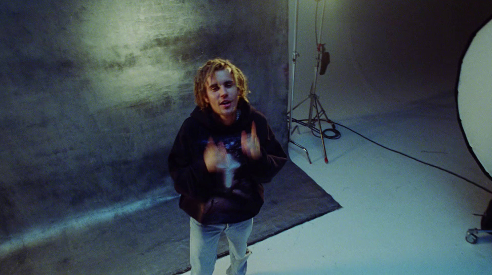 a man standing in front of a camera in a room