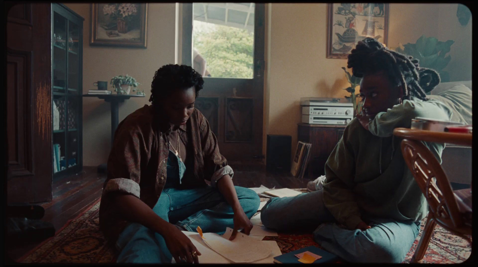 two women sitting on the floor in a living room