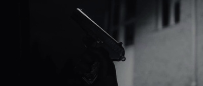 a person holding a gun in a dark room