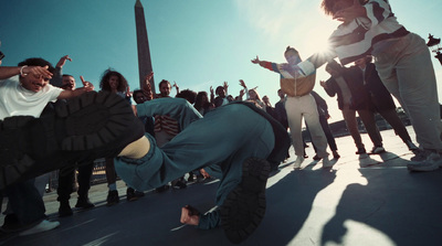 a group of people standing around a person on a skateboard