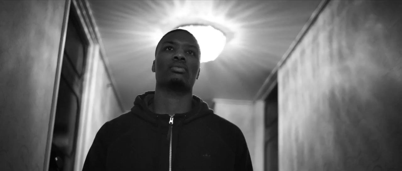 a man standing in a hallway in front of a light