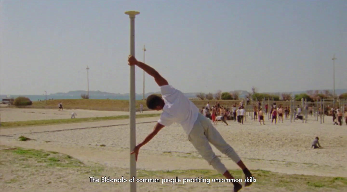 a man hanging upside down on a pole