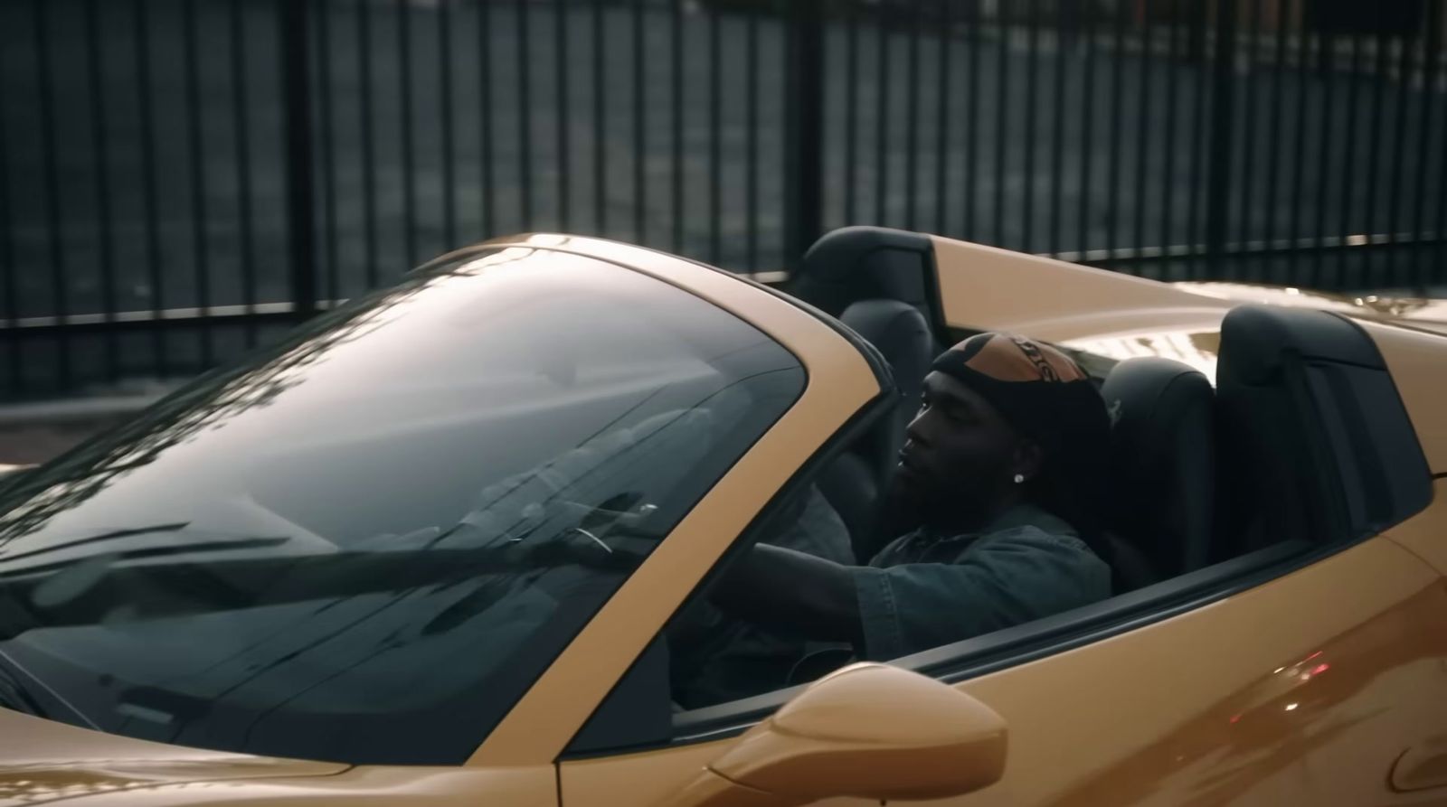 a man sitting in a yellow sports car