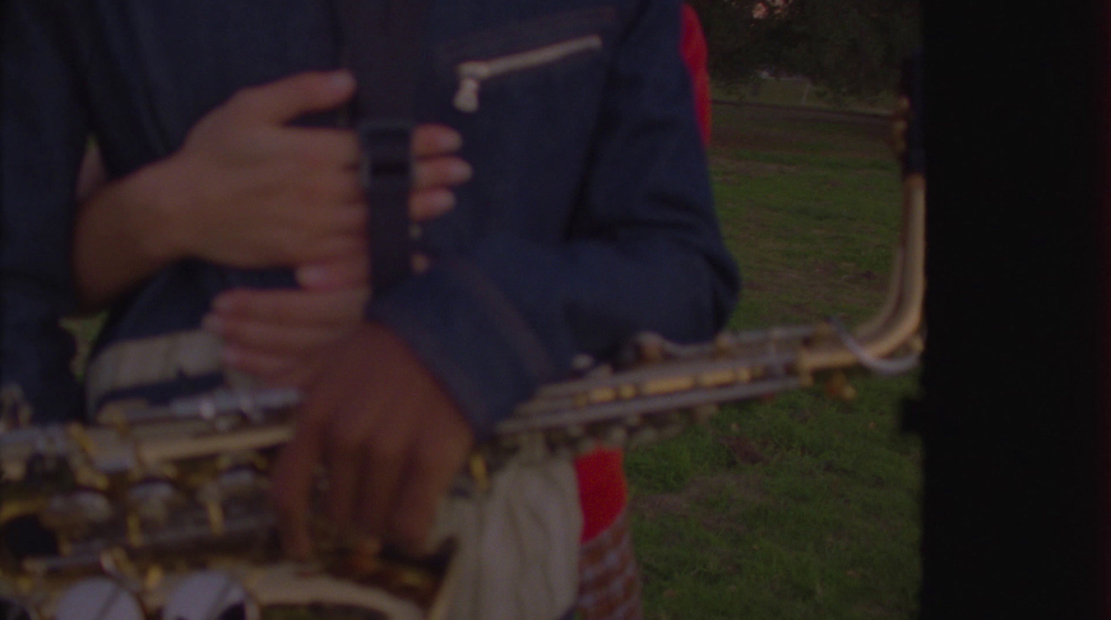 a close up of a person holding a saxophone