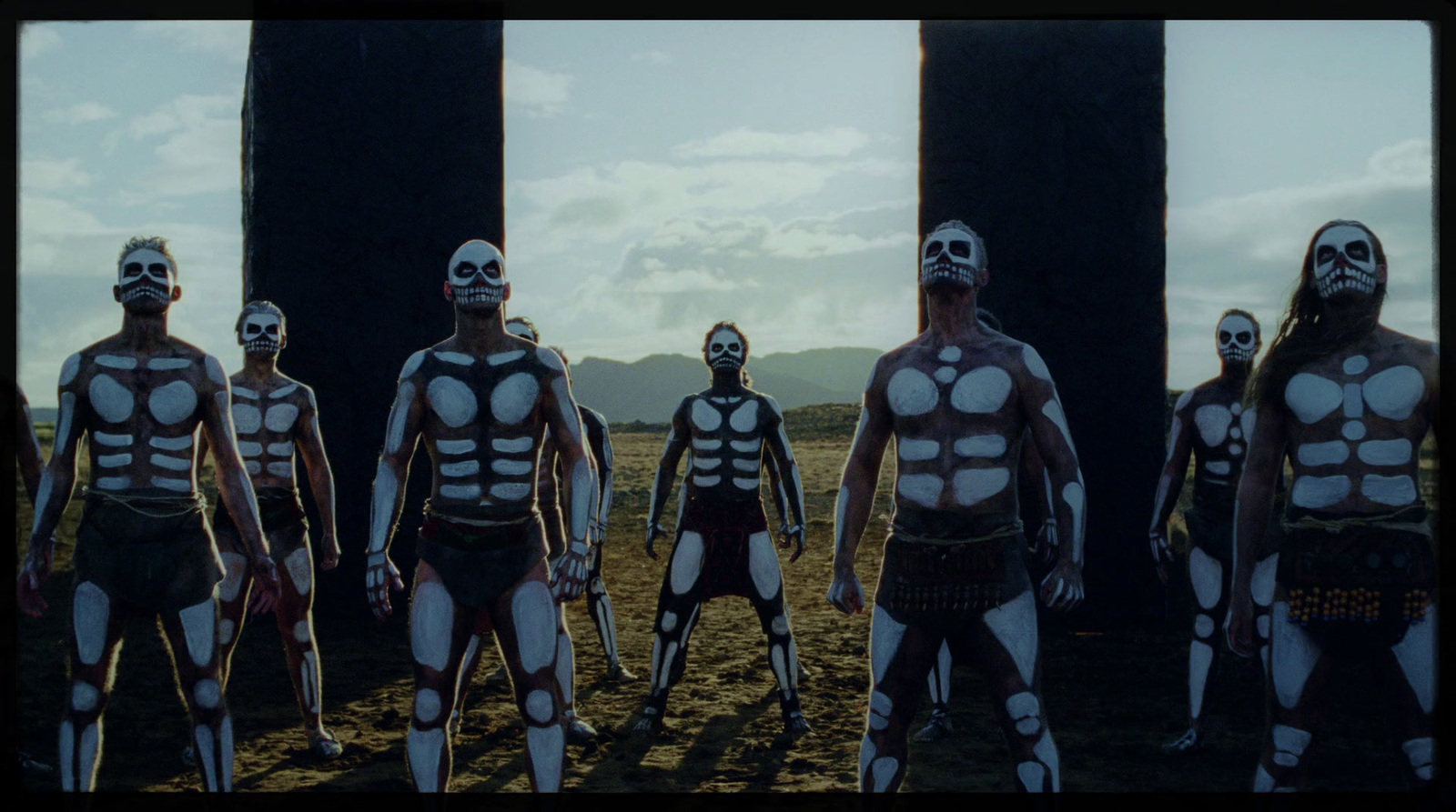 a group of men in skeleton costumes standing next to each other