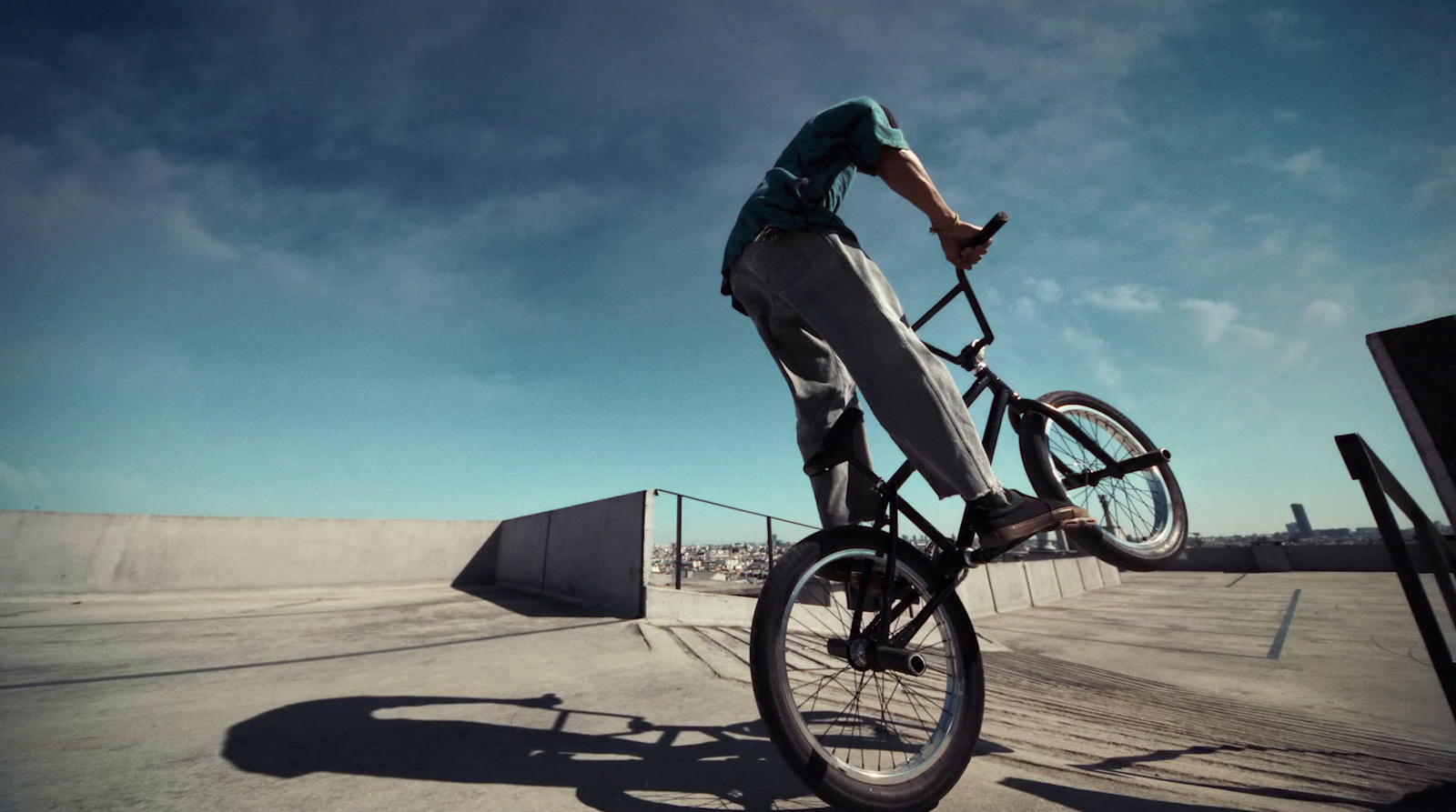 a man riding a bike up the side of a ramp