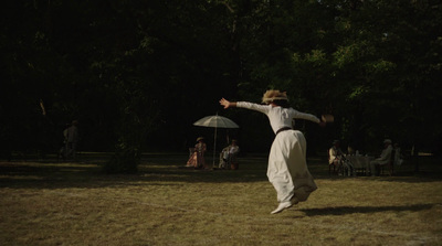 a person in a field with an umbrella