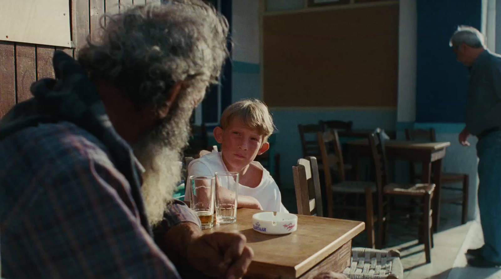 a man sitting at a table with a glass of water