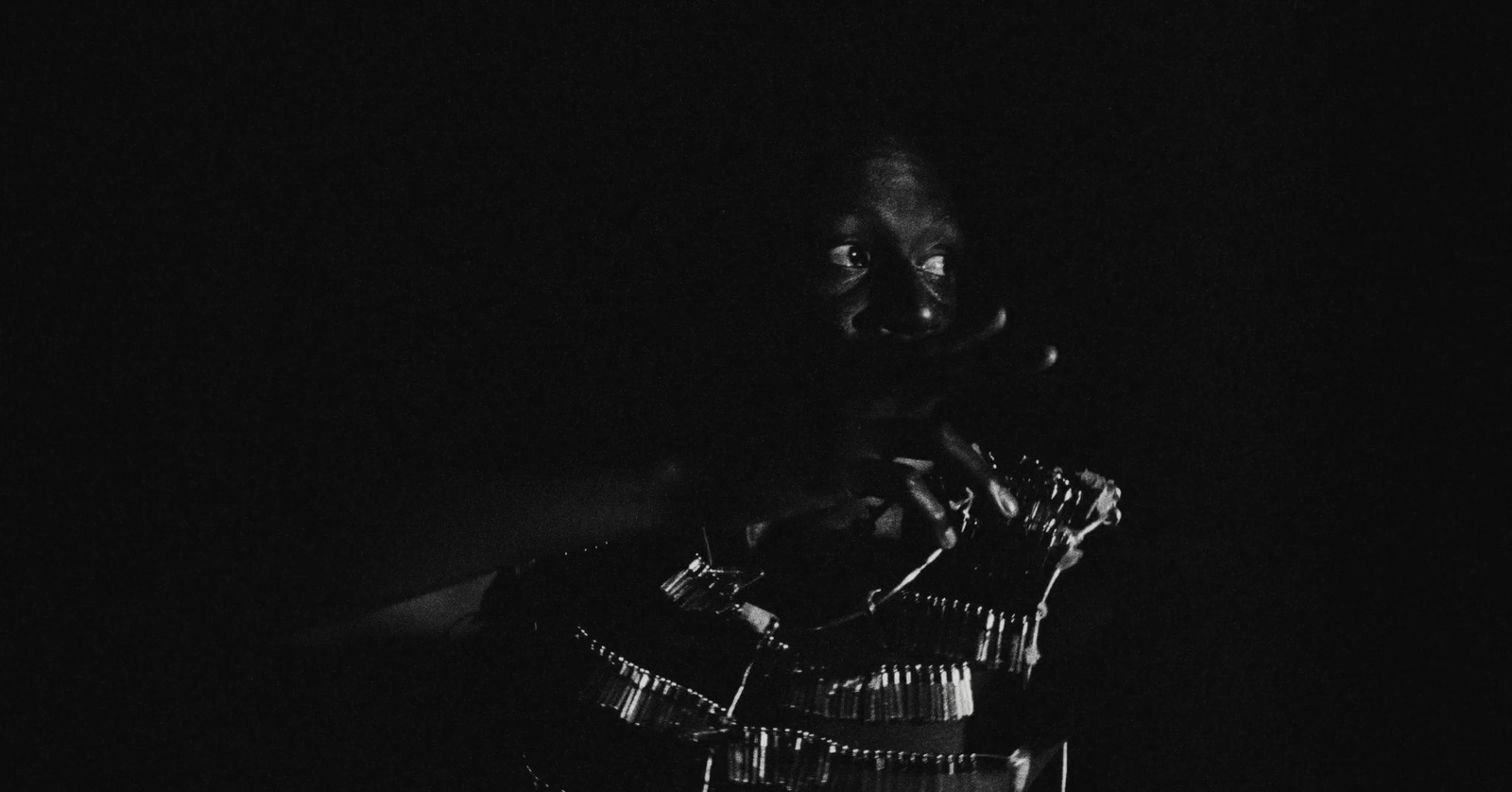 a black and white photo of a person in the dark