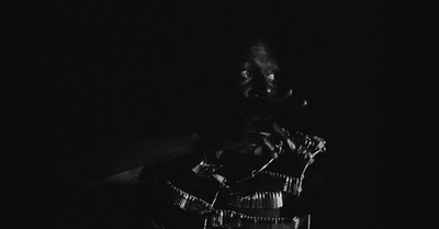 a black and white photo of a person in the dark