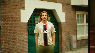 a man standing in front of a brick building