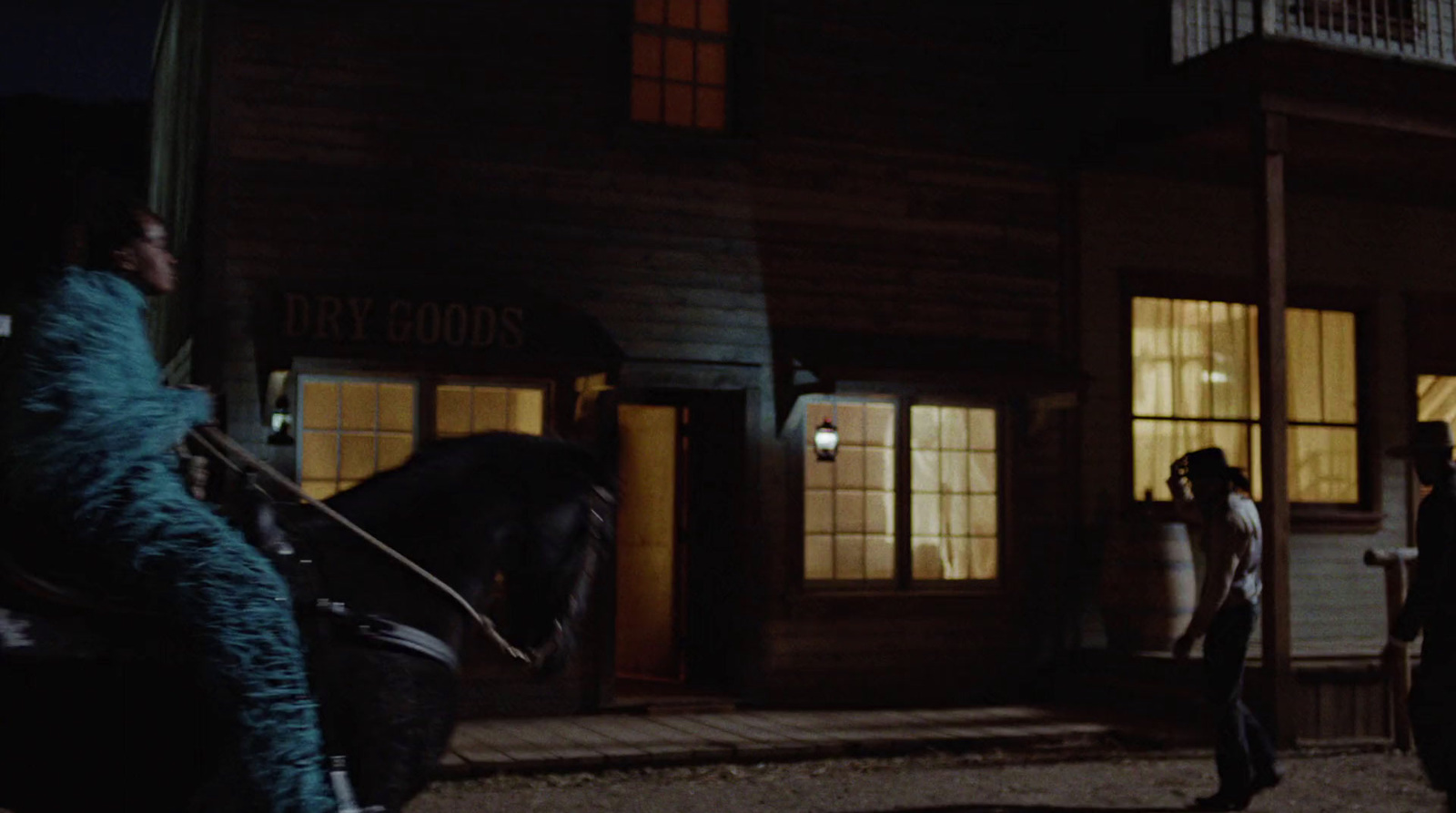 a man standing next to a horse in front of a building